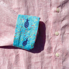 Island Coral/Pineapple Print ++ pink long sleeve linen shirt with blue cuffs and pineapple accents