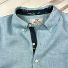 Caribbean Blue/Flamingo Print ++Man-Wearing-Caribbean-Blue-Linen-Shirt-Flamingo-Accent-Cuffs